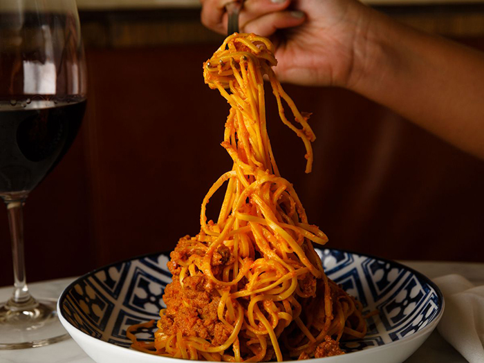 Manetta’s italian restaurant in New York bowl of spaghetti pasta and wine 