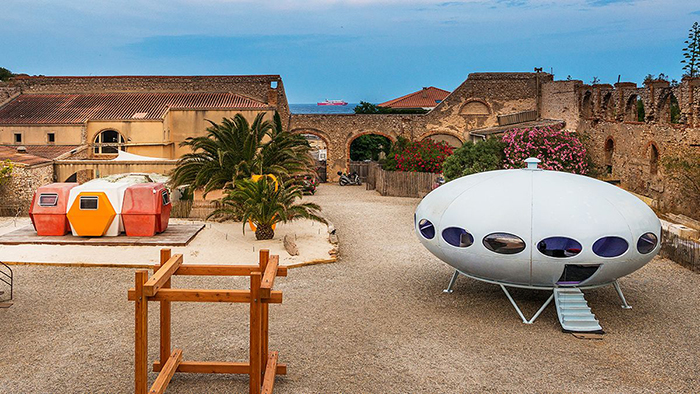 Futuro house in a yard buildings palm trees 