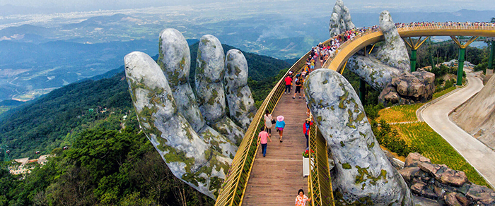 Hand bridge Vietnam close up hands tourists aerial view hills mountain top