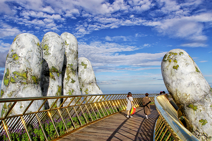 Golden Hand Bridge Vietnam close up hand tourists bridge 