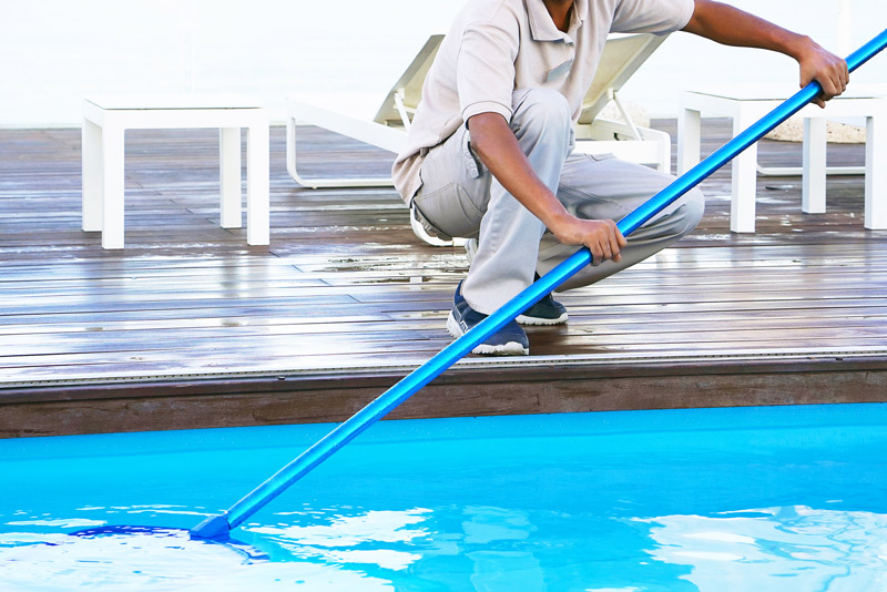 Man cleaning pool