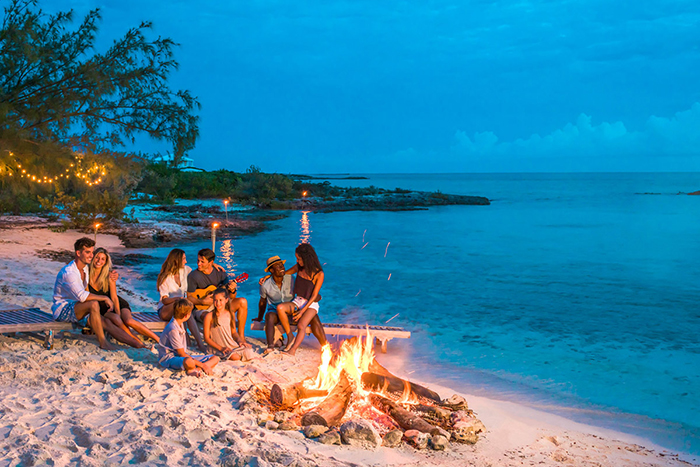 exotic places the bahamas friends around the fire couples playing the guitar