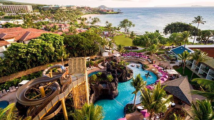 Top Hawaii Resorts view from above outdoor pool water slide palm trees white beaches