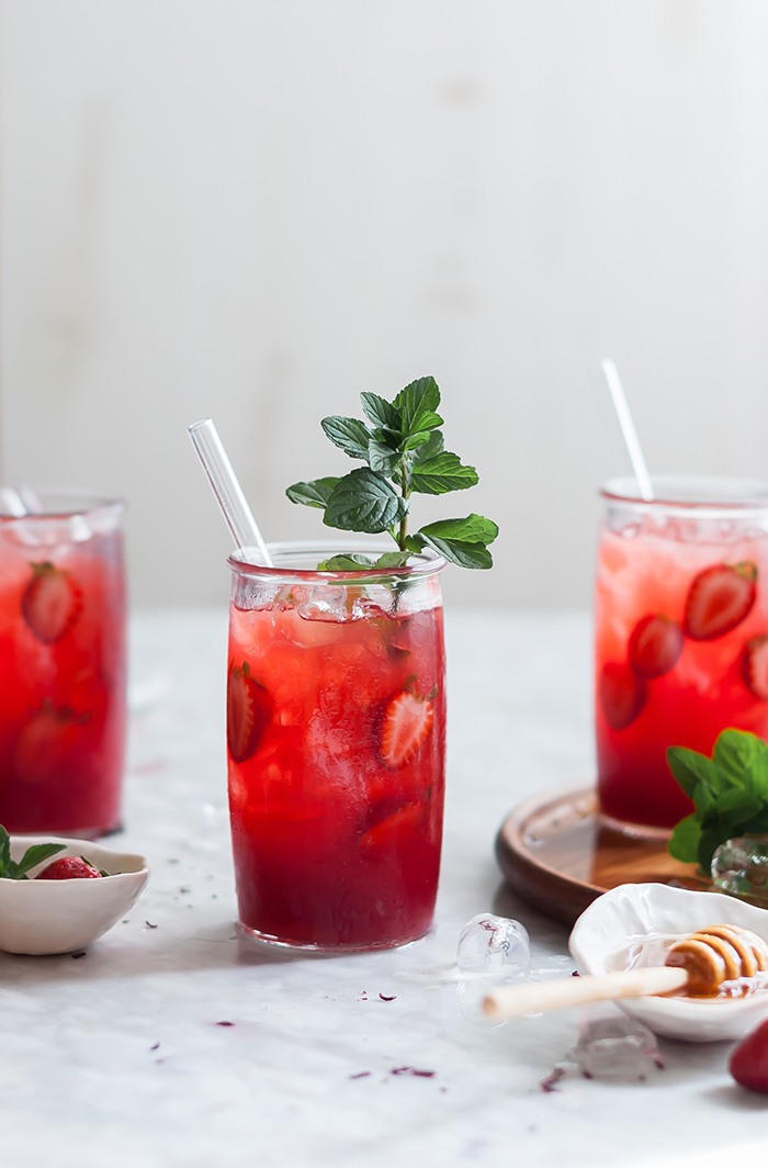 Summer drinks ideas mint and strawberry lemonade in tall glasses with a straw