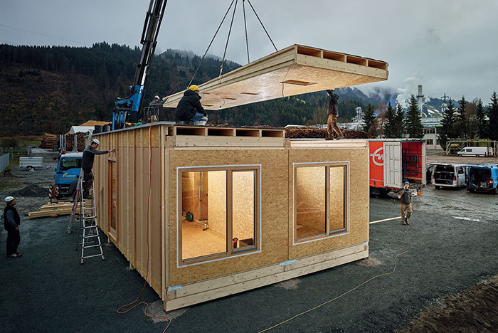 Quick Build Homes Construction Site building work people placing a roof of a prefabricated home