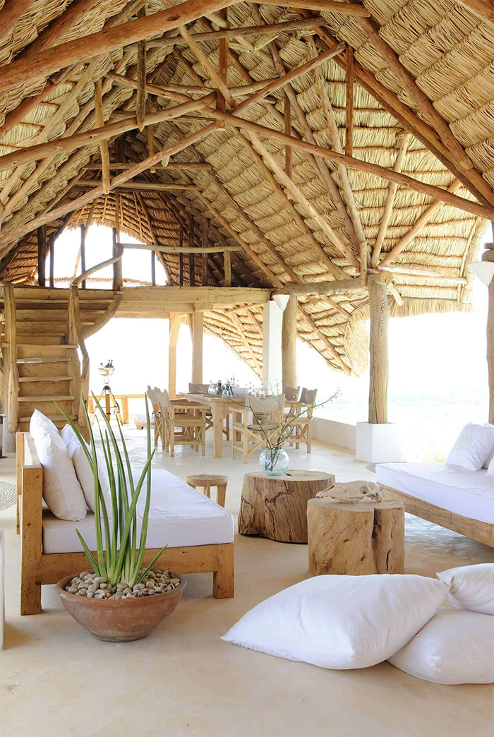 Rustic summer house with high rattan ceiling white and wooden furniture coastal style