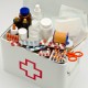 Open first aid box filled with medical supplies in white background