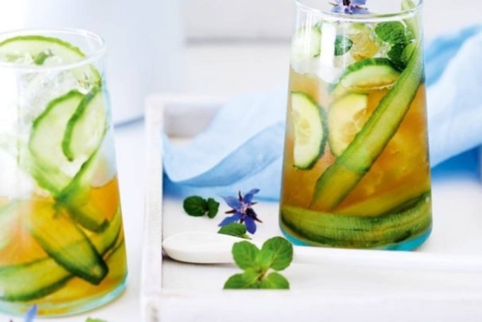 cucumber tea in glasses with slices of cucumber and mint leaves