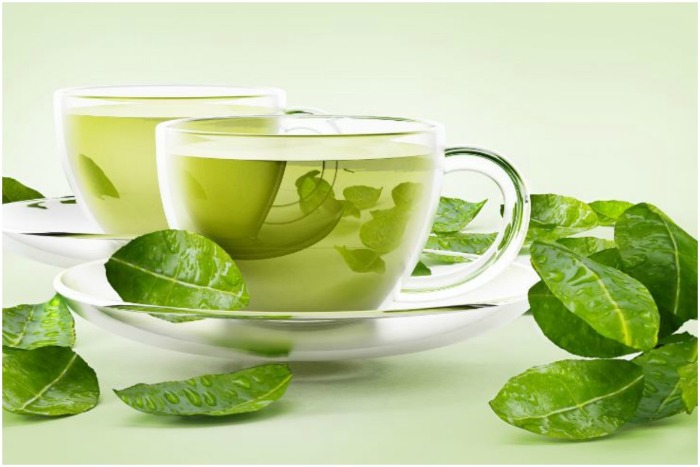 two glass cups of green tea green tea leaves