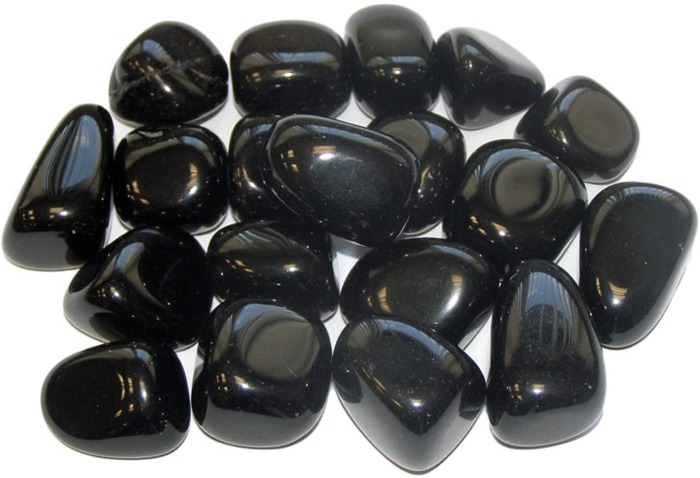 black obsidian stones on a white background shiny crystals