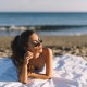 woman with black sunglasses on the beach