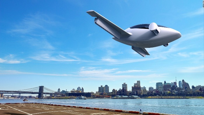 air taxi flying over a river in a blue sky and city skyline