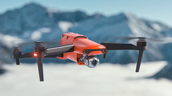 red Autel EVO 2 close up flying in snowy mountains