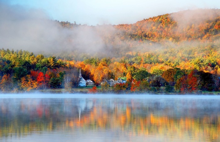 Fall lake scenery autumn foliage and fall mist over the water