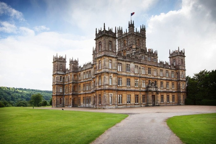 Highclere castle in the background surrounded by green field