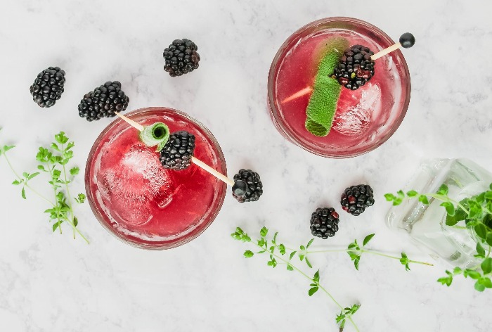 fruit and herb cocktails with blackberries photo from above on a white background