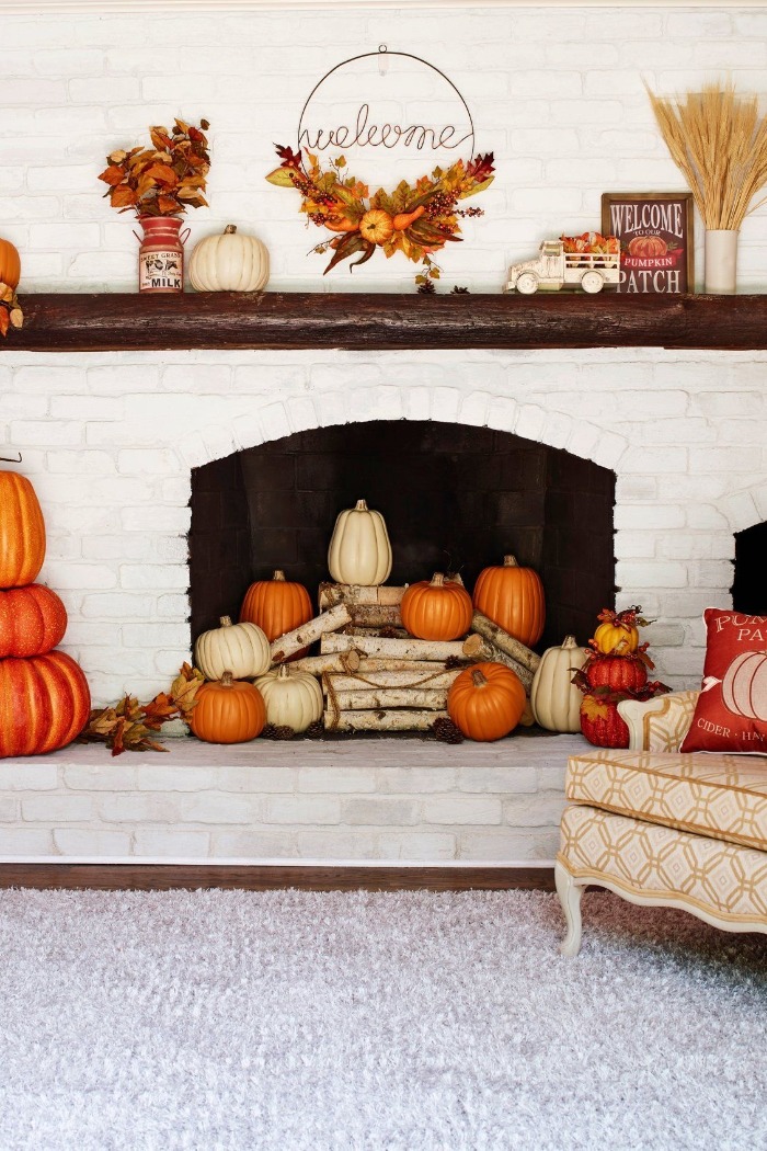 fireplace fall decoration with pumpkins and leaves