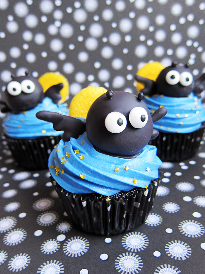 Cute black bat cupcakes with blue topping yellow back and black heads