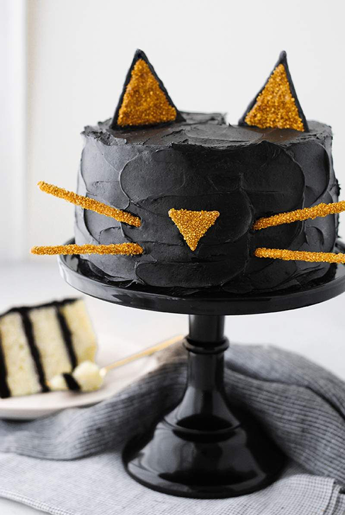 Halloween cat inspirations black cat cake with yellow ears, nose and moustache sticks