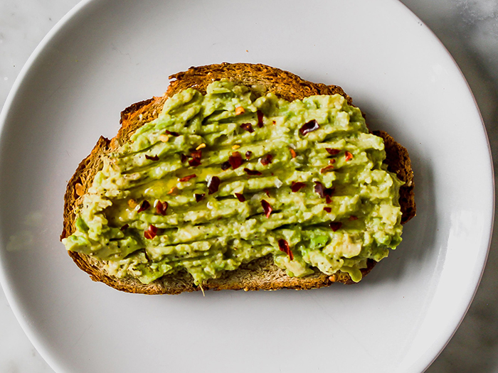 Best fall healthy breakfasts avocado toast on a white plate with seeds on