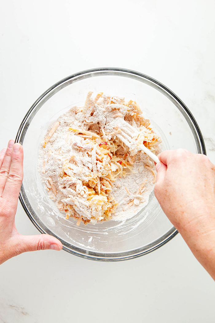 Healthy seasonal foods breakfast oatmeal hands mixing oats in a glass bowl