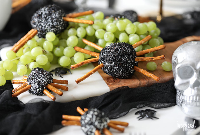 Cheesy spiders with sticks and grapes