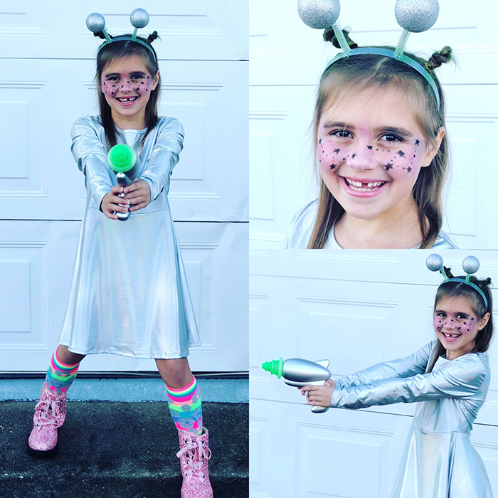 Halloween costume for a child with silver dress pink shoes and a silver gun