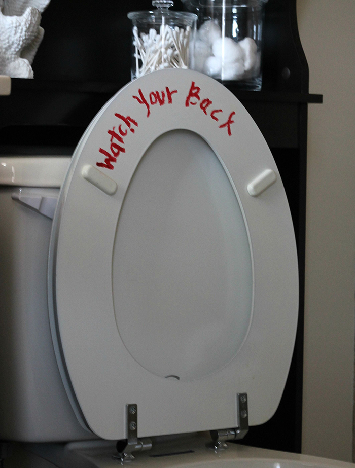 Halloween red lipstick creepy message on the toilet seat