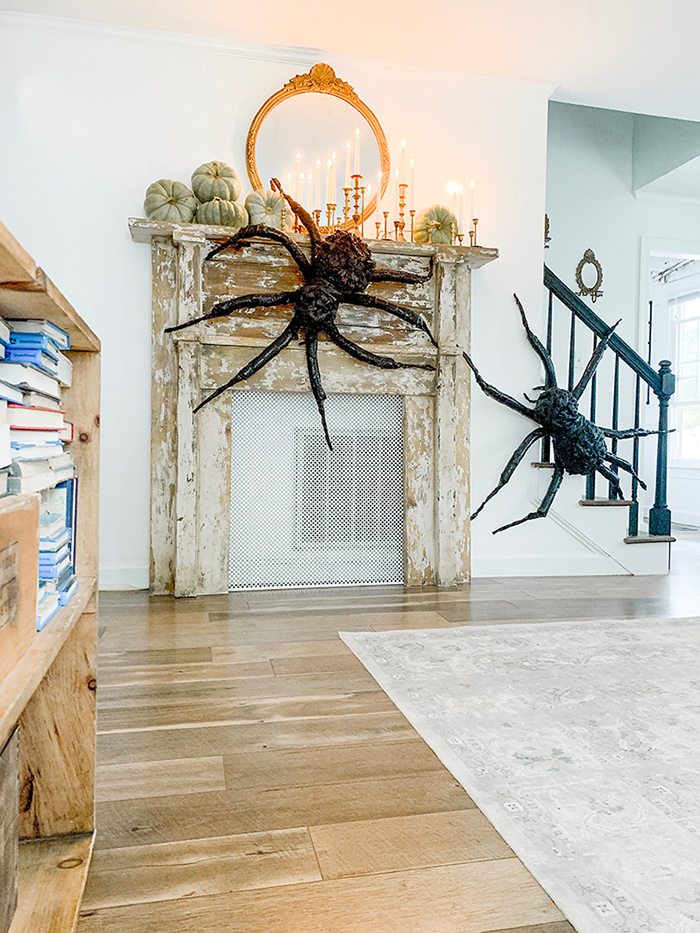 Transforming your home for Halloween two giant black spiders in a modern interior on a vintage fireplace