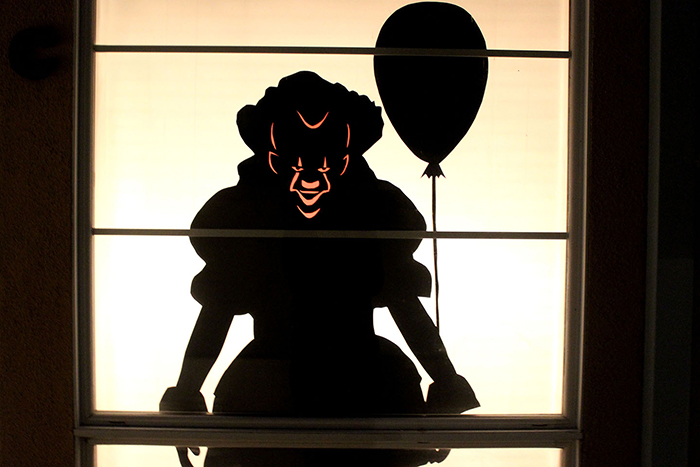 Halloween window decor idea spooky black clown with a balloon