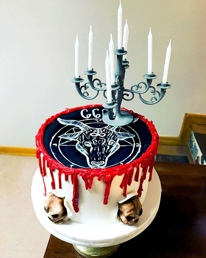 Halloween cake with black top and animal head candle holder 