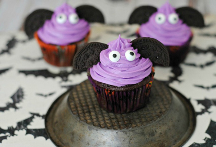 Spookiest bat cupcakes with purple topping, oreo ears and googly eyes