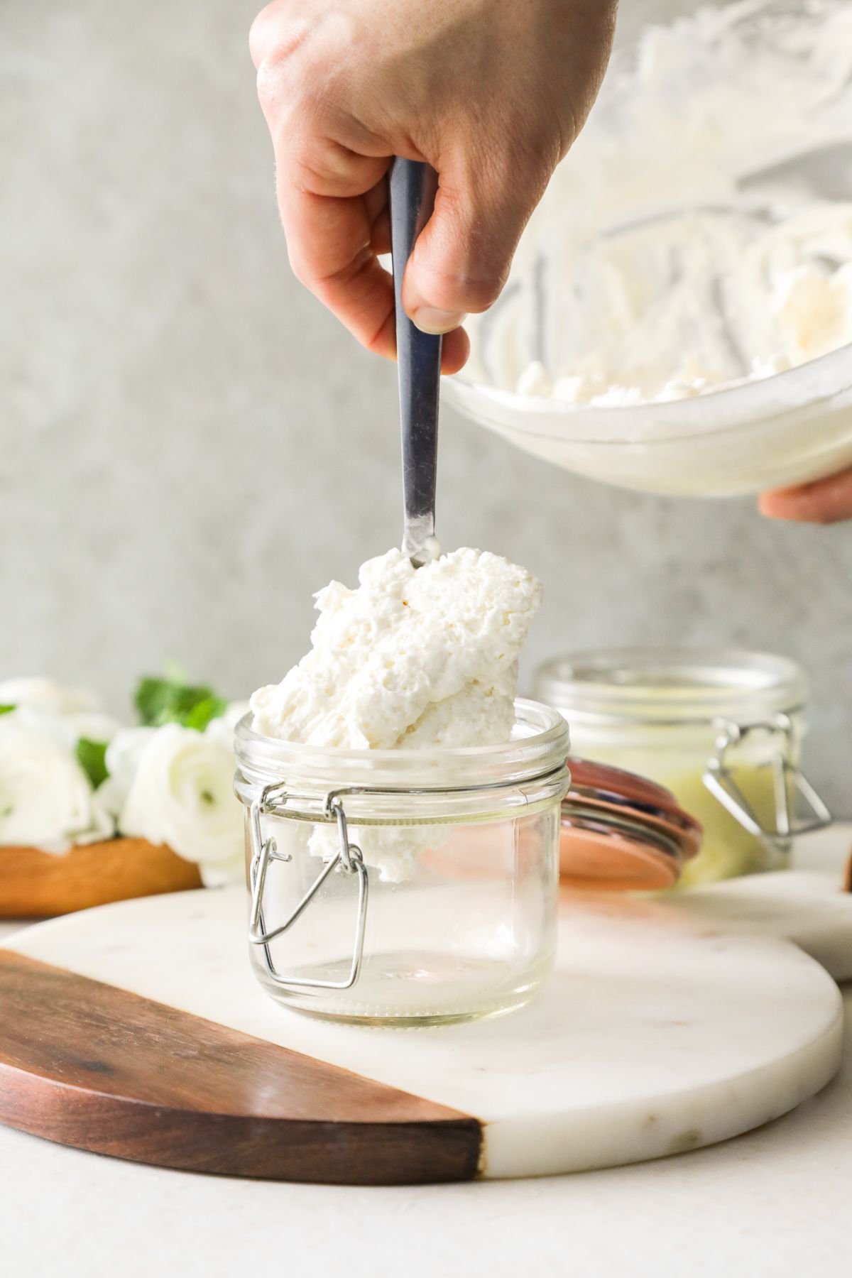 best natural cosmetics with shea butter hand mixing butter in a glass jar