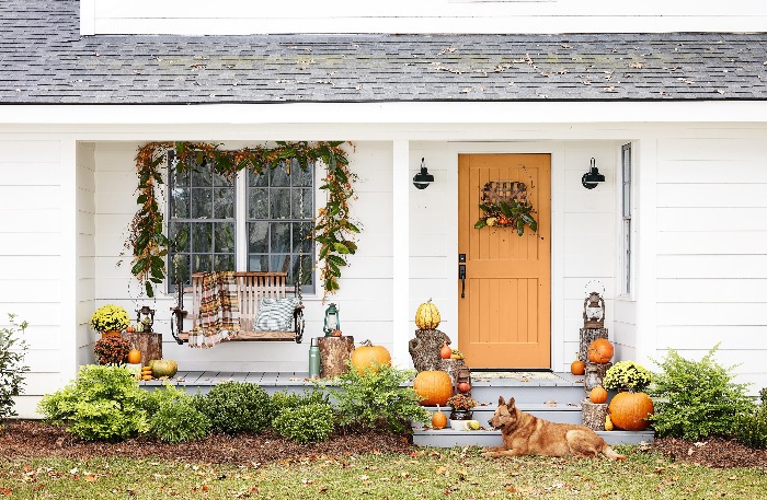 DIY Fall Wreaths and fall decoration on a yard with a dog