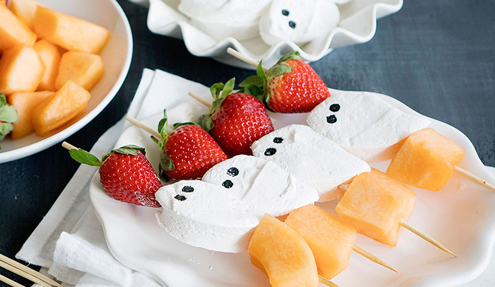 Healthy Halloween snacks on a stick strawberries melon and marshmallow ghosts