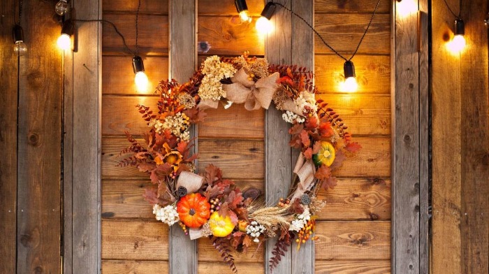 outdoor wreath with lights autumn themed leaves and pumpkins