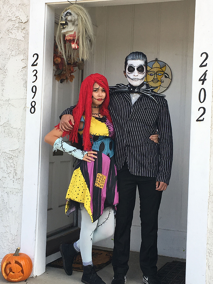 Halloween costumes Jack and Sally at a white front door 