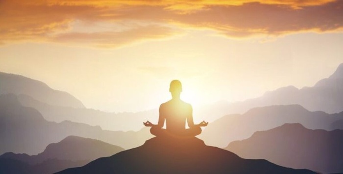 abundance meditation on the top of a mountain monk sitting in meditative pose