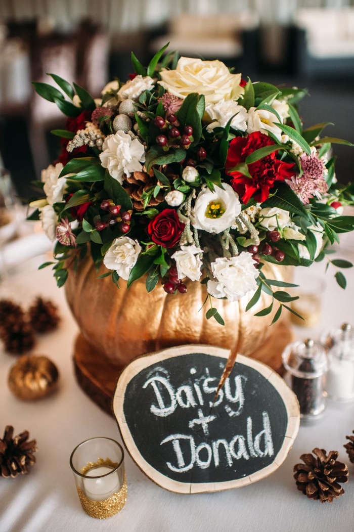 Thanksgiving color scheme golden pumpkin with a bouquet inside in white red and green