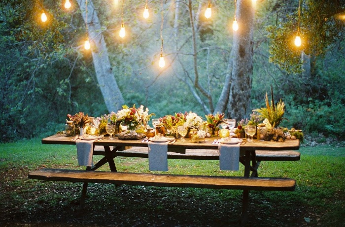 outdoor table thanksgiving themed wedding in a wood with outdoor lights