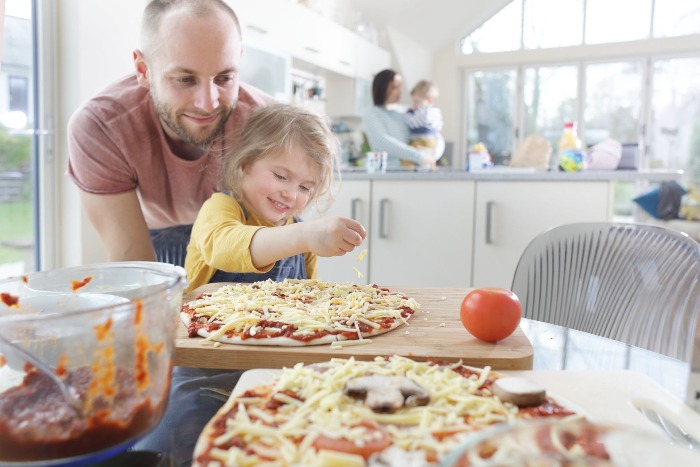 holiday season at home with the family a family with two little kids cooking pizza