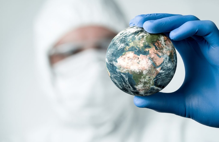 planet is healing during the lockdown scientist holding a model of the earth