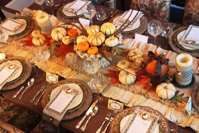 Thanksgiving decor table with abundant decorations pumpkins feather and fall motives 