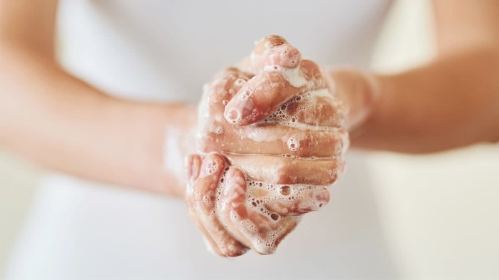 woman's hands washing with soap white foam white dress