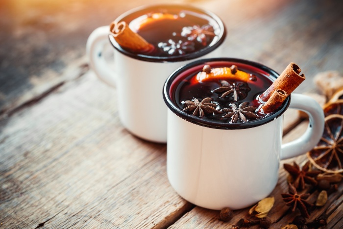 warm winter mulled wine with cinnamon sticks anise cloves and orange slices 