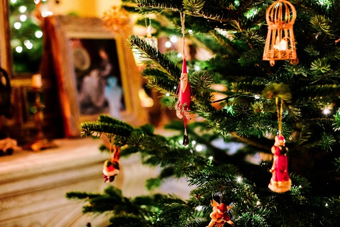 christmas traditions decorated tree indoors with hanging ornaments 