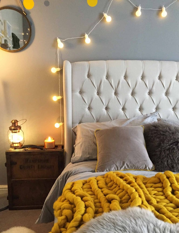 fairy lights in the bedroom over the bed and a small lantern