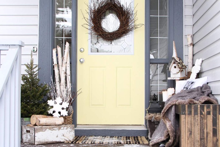 Front door and porch decor branch wreath logs and snowflake decorations