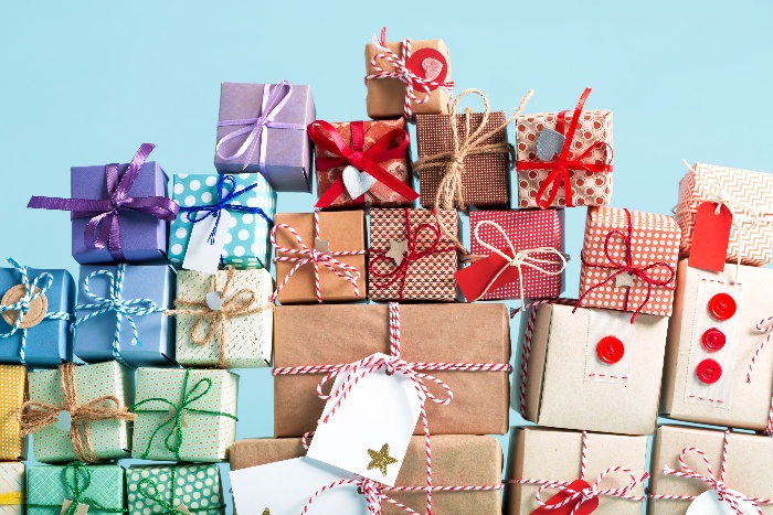 gift shopping a pile of colorful christmas gifts wrapped in different paper with ribbons