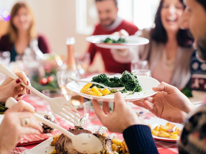 holiday eating festive table with people sharing good food and dishes